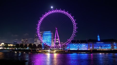 LONDON, circa 2021 - Stunning night view of the London Eye, the Thames and the Southbank in London, England, UK
