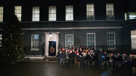 LONDON, DEC 2021 - A choir and band are seen performing at Downing Street, during the traditional Christmas ceremony when lights are turned on
