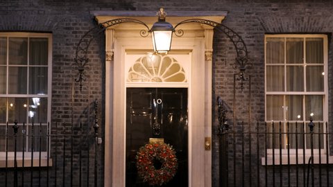 LONDON, DEC 2021 - Night view of 10 Downing Street, the official residence of the British PM, decorated with a Christmas wreath
