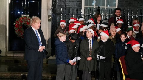 LONDON, DEC 2021 - Boris Johnson joins the choir and band at Downing Street, during the traditional ceremony when Christmas lights are switched on
