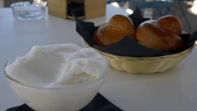 Typical Sicilian dessert. Fresh homemade brioches with an almond granita. Video 4K