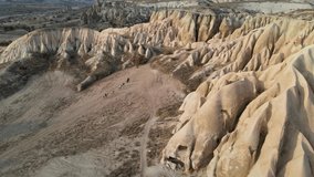 Volcanic ridge in Goreme, Cappadocia, and rocks with ancient heritage in Goreme National Park at autumn sunny day, Aerial drone view