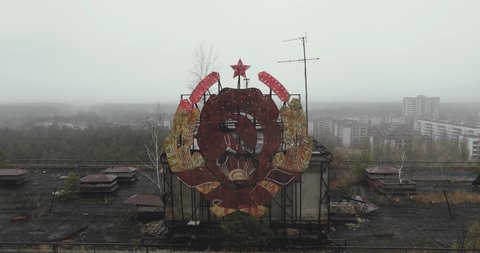 Drone view close up over the sign of USSR on the roof in city of Pripyat near the Chernobyl nuclear power plant in Chernobyl exclusion zone. Ukraine. Ghost city after disaster