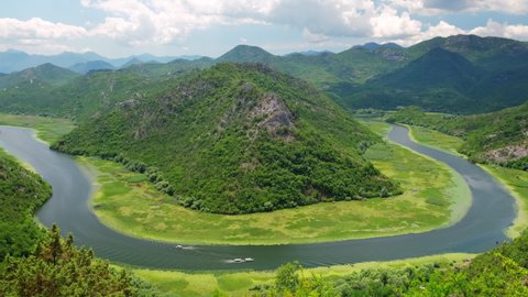 Rijeka Crnojevica river canyon summer landscape near the coast of Skadar lake in Montenegro. The river makes a turn between the mountains and flows backwards.