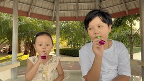 Asian boys and girls whistle in slow motion park