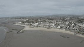 Aerial footage of Morecambe bay on a sunny afternoon. Coastline and promenade 