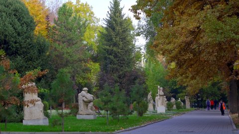 Bishkek, Kyrgyzstan - October 2021: Cleaner walks along the avenue of monuments