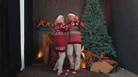 Cheerful smiling Caucasian married senior couple grandparents in decorated room celebrating New Year together in evening. Wife and husband dancing near glowing xmas tree on Christmas. Holidays concept - Powered by Shutterstock - Get 15% off with code: PIKWIZARD15