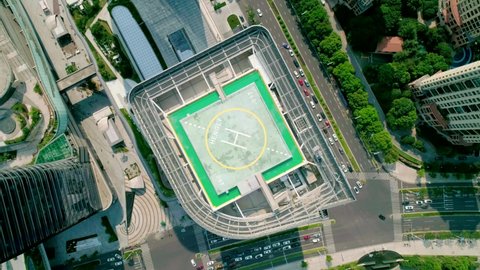 Suzhou, China - September 5, 2020: Helipad on the rooftop of the modern skyscraper. Aerial drone view of helipad on the roof of a skyscraper in downtown.