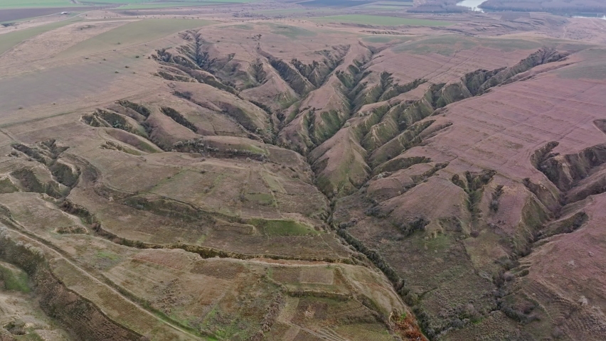 Geological landscape. Erosion of the soil, weathering, the formation of ravines and cracks in the earth and clay