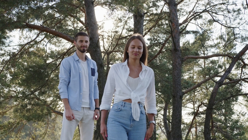 Closeup romantic people walking in park. Portrait of happy man and woman spending time at summer outdoors. Tenderness feeling. Camera mooving turning over
