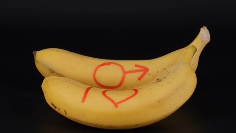 Banana on a black background. A symbol of masculinity, masculine strength.