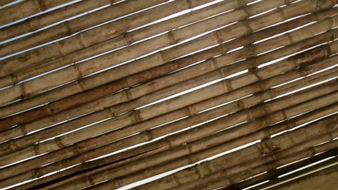 Tropical ceiling bamboo sticks with sunlight sunflare shining through cracks