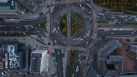 Aerial birds eye overhead top down panning view of cars stuck in traffic jam. Multilane road around large and complex intersection in city centre. Warsaw, Poland