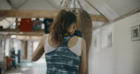 Woman Training with Boxing Bag