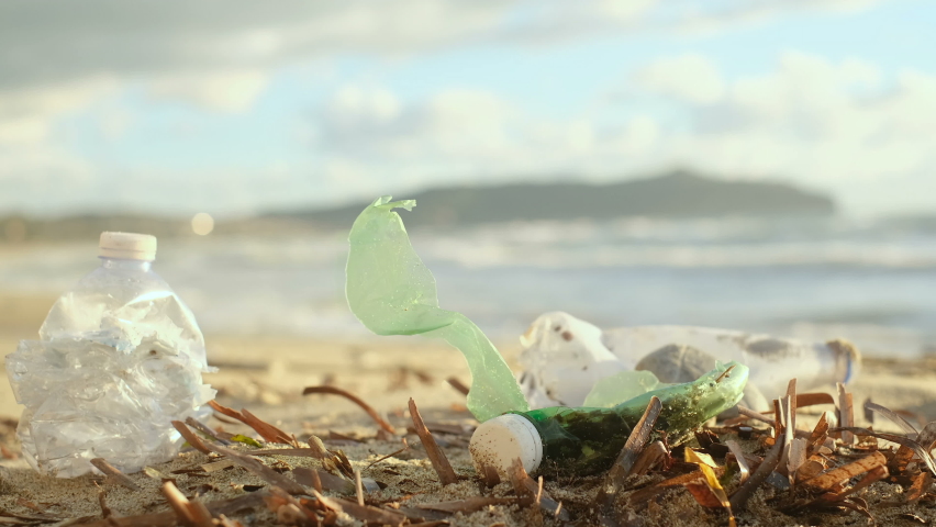 Plastic bottles discarded on pollution contaminated ocean sea coast habitat, environmental nature waste | Shutterstock HD Video #1083476050