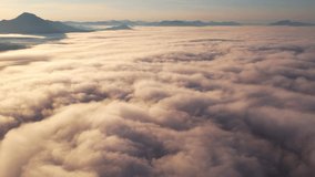 4K Aerial video Beautiful sunrise above dense clouds and fog in the morning, Cinematic drone shot.

