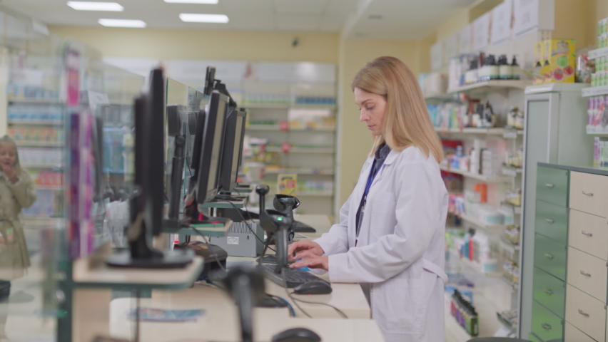 Father and daughter coming to drugstore, consulting with female pharmacist doctor, receiving advice and medication. Apothecary store. Family. Consultation.