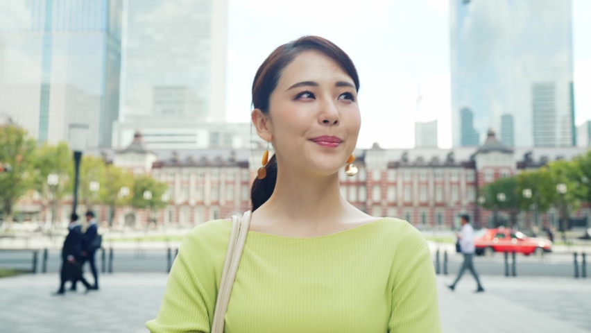 Young asian woman walking in the city.