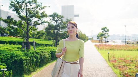 Young asian woman walking in the park.