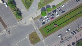 A bird's-eye view photo. Clip. In the photo, a big city with a green park for people, with beautiful green grass and a road with moving cars.