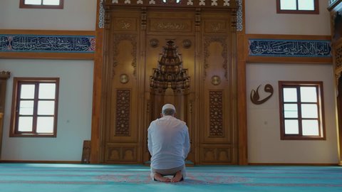 Muğla, Turkey-06.01.2021:Muslim island in turban praying in mosque. Concept of worship during Ramadan and religious holidays. Man praying and worshiping on a mosque carpet. 
