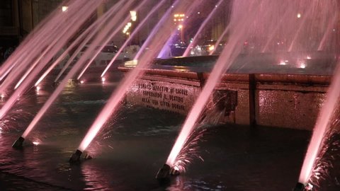 Genoa, Italy - December 4 2021: in the evening, the beautiful fountain, symbol of the city, located in Piazza De Ferrari, illuminated for the Christmas holidays