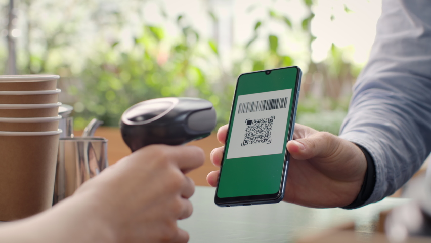 Pay by qr code on phone screen at coffee bar. Qr reader scans electronic card to transfer e-money of client wallet. Payment scanner in barista hands close-up. Buyer in restaurant or food supermarket Royalty-Free Stock Footage #1083505702