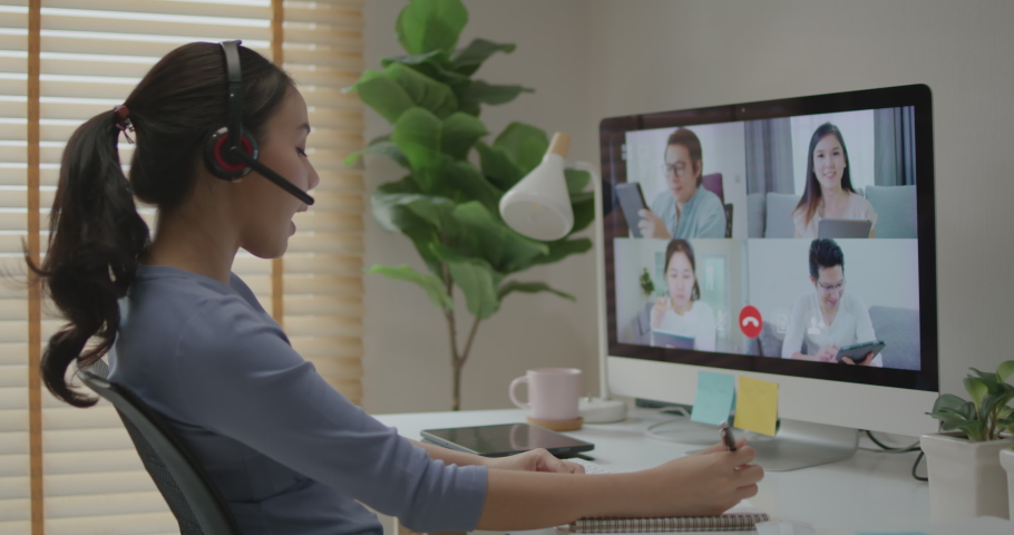 Happy smile asia young woman learn mba college class on wifi webcam video call in desktop pc screen with cowork friend workforce group talk in sale report. Smart job work at home for staff workspace. | Shutterstock HD Video #1083512443