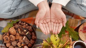Close-up top view 4k stock video footage of two empty cupped female hands isolated on colorful autumn background