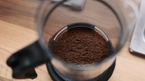 close up lockdown slow motion shot of steaming hot water being poured onto fresh coffee in french press - Powered by Shutterstock - Get 15% off with code: PIKWIZARD15