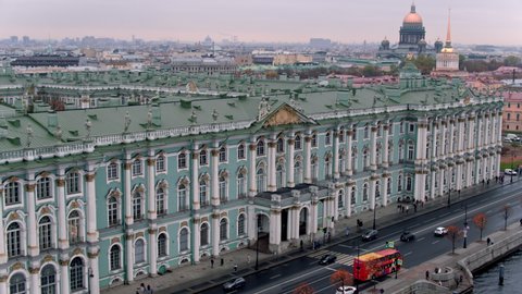 Aerial view of Saint Petersburg cityscape Hermitage Imperial Palace sculpture facade, Main Admiralty, St. Isaac's Cathedral. Road traffic. People walk cross the road. City life Russia. Promenade