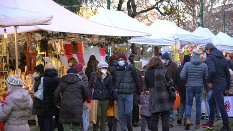 Europe, Italy , Milan December 2021 - people with masks walking for the Christmas market during Covid-19 Coronavirus epidemic - Traditional obej obej market 