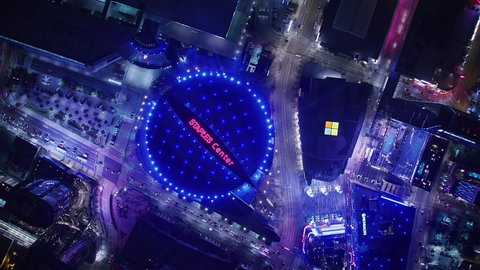 Los Angeles, California. United States. Circa, 2019. Staples Center. Overhead aerial view of the famous multi-purpose arena in downtown LA. Famous brands and logos shining in the night. Shot in 8K