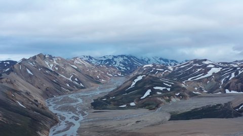 Birds eye of beautiful and unspoiled glacier snowy Thorsmork valley in Iceland. High angle view of Porsmork icelandic highlands with Krossa river and mossy cliffs. Amazing on earth
