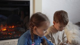 Childhood, education, hobby, family, friends, friendship concept. Happy young mother mum babysitter with little preschool kids children spend time playing card game on floor at home by fireplace - Powered by Shutterstock - Get 15% off with code: PIKWIZARD15