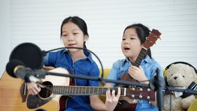 Children are showing their singing and playing music online through social media, education concept, technology.
