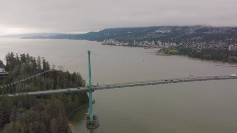 Lions Gate Bridge in Vancouver's harbor with the pacific ocean in the background, Stanley Park in 4K