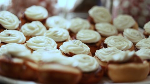 Closeup of Swirls of Piped Buttercream Frosting on Cupcake Tartlets at Wedding Reception Party, dolly out