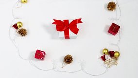 Lighting and small gift box pinecone 4K video on the white background for Christmas lighting and decoration idea.