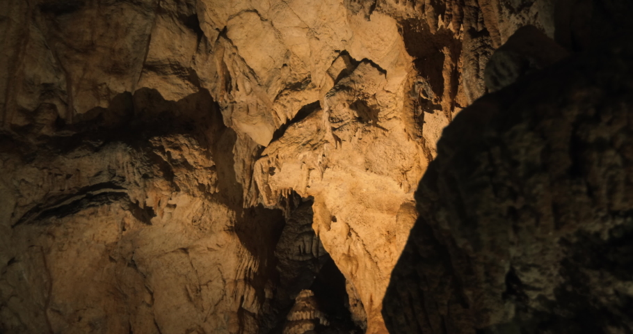 Cave landscape in the middle of the mountain with stalactites and stalagmites. Beautiful cinematic video of nature in with stones in the middle of the cave. Royalty-Free Stock Footage #1083556675