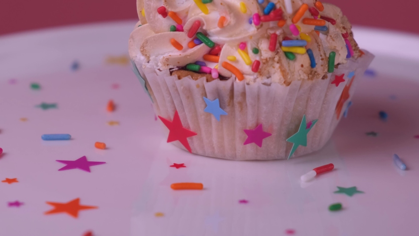 Spinning cupcake or cake with a candle on a pink background, the concept of celebrating the birthday of a child or girl. Royalty-Free Stock Footage #1083558712