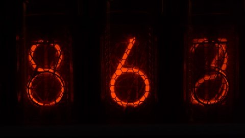 Retro vacuum tube display on the device counts seconds. Displaying numbers on a vintage lamp timer, close up, nixie tube indicator. Glow discharge indicator