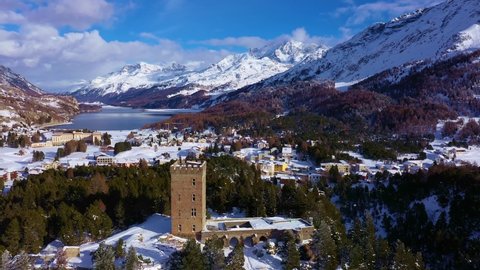 Aerial drone footage of the ancient fortification at the top of the Maloja pass in the alps in canton Graubunden in winter in Switzerland. Shot with a rotation motion toward lake Sils in the back. 