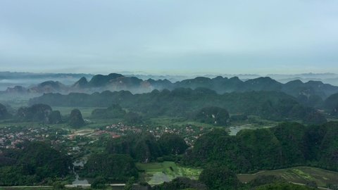 aerial drone shot of Ninh Binh National Park, Vietnam. Incredible unique landscape, King King shooting location, fog above mountains.