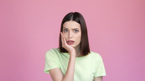 Astonished lady horrible novelty disappointed isolated pink color background