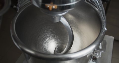 Gingerbread mixture is being poured into a dough mixer, cooking dough, 4k