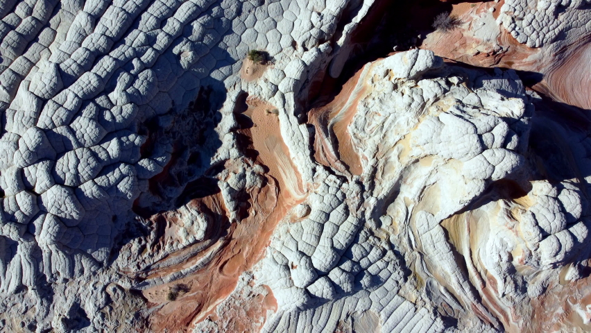 Top down panning drone shot of the rock formations of White Pocket at the Vermillion Cliffs National Monument, Arizona, Unites. Royalty-Free Stock Footage #1083574336