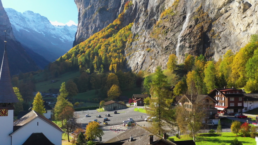 Revealing drone shot of the Staubbach waterfall church in Lauterbrunnen Bernese Oberland Switzerland Royalty-Free Stock Footage #1083575785