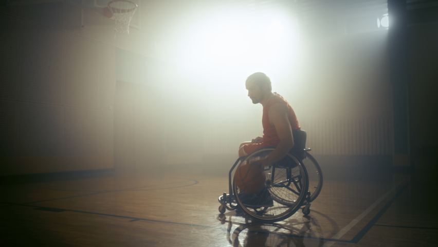 Wheelchair Basketball Player Wearing Red Uniform Shooting Ball Successfully, Scoring a Perfect Goal. Determination, Training, Inspiration of Person with Disability. Dolly Slow Motion with Warm Colors Royalty-Free Stock Footage #1083576427